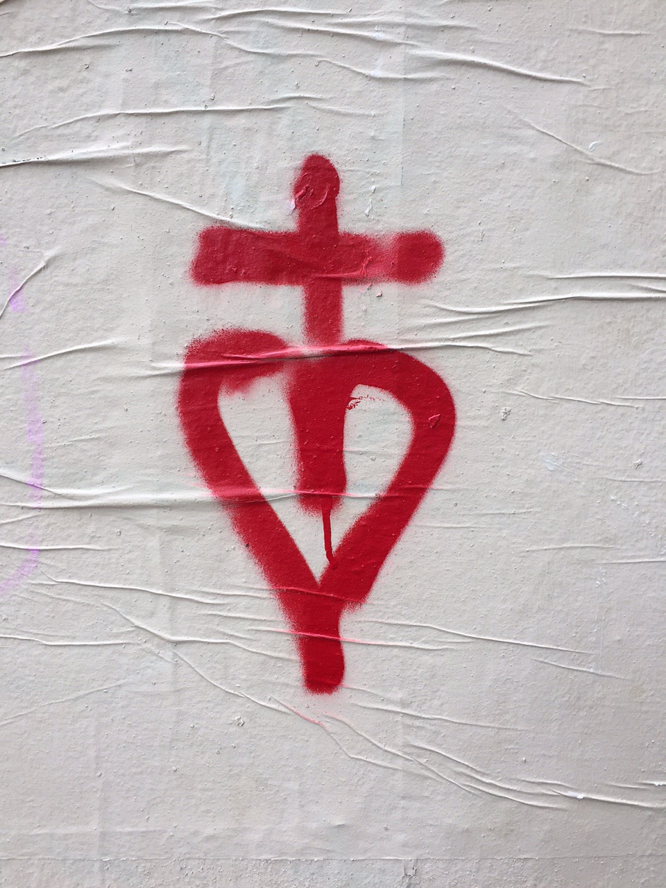 Heart with cross graffiti shows art on the streets